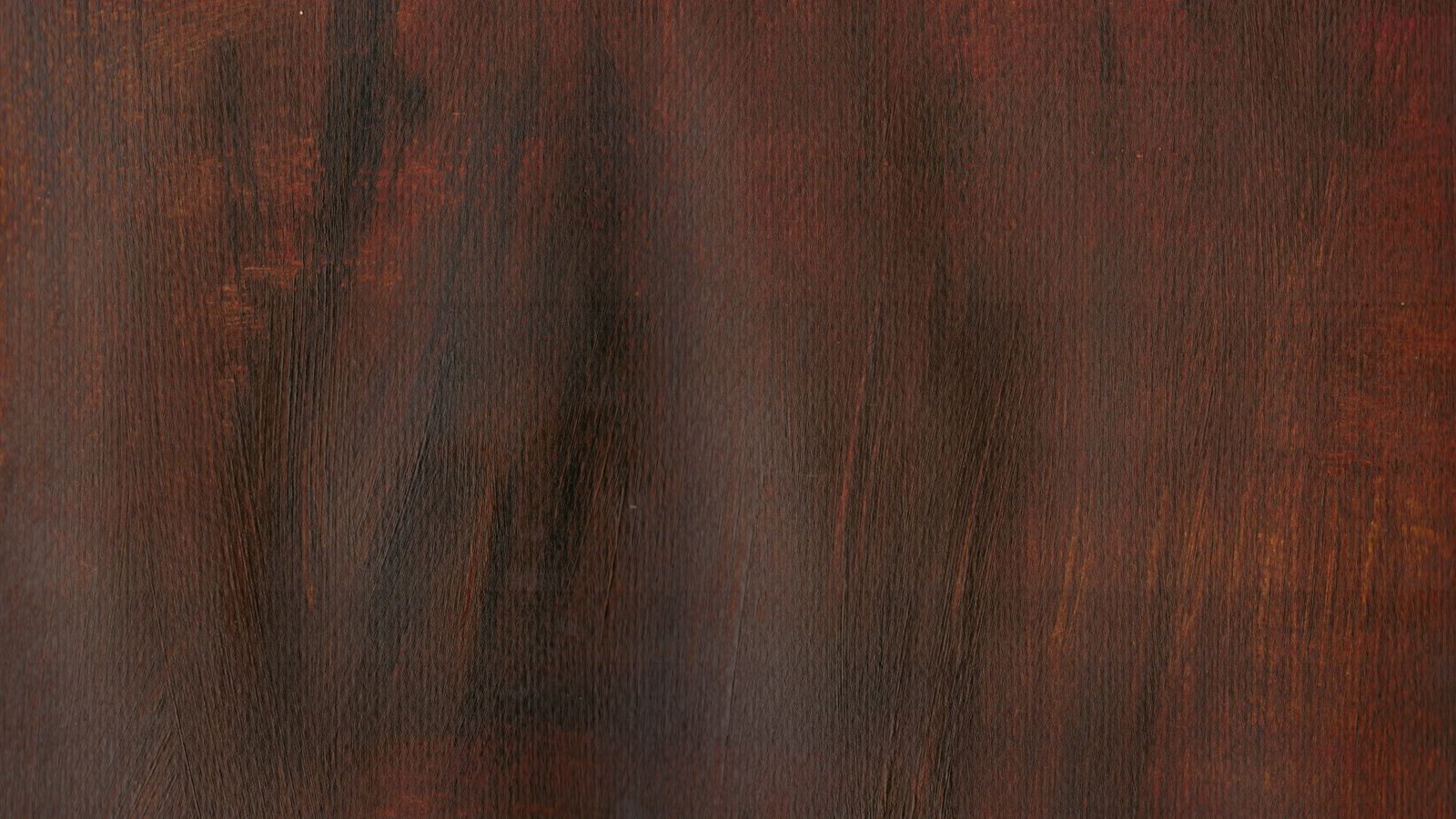 Close-up of dark walnut grain freshly finished with Danish oil, showing the deep figure and low satin sheen